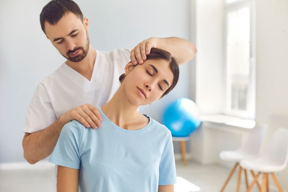 licensed,chiropractor,or,manual,therapist,doing,neck,stretch,massage,to